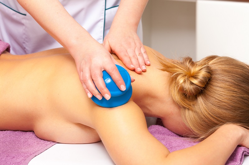 Beauty treatment concept. Woman getting spa therapy cupping glass vacuum massage in salon. Alternative medicine procedure, body care healthy lifestyle.